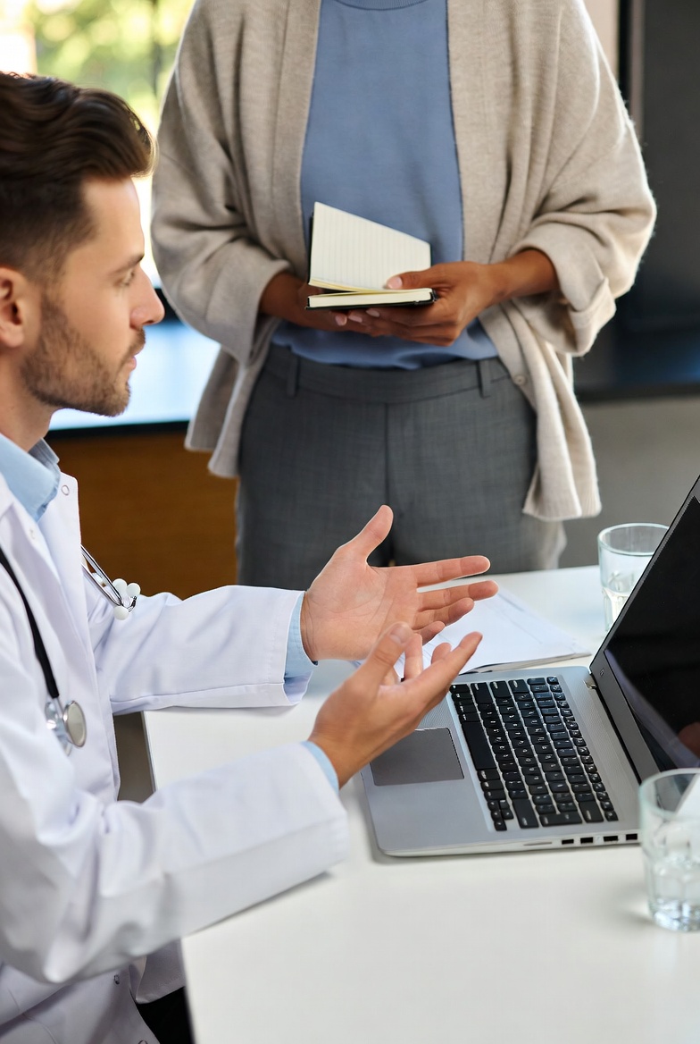 A nutrition professional reviewing a personalized food plan with a client in a calm consultation setting